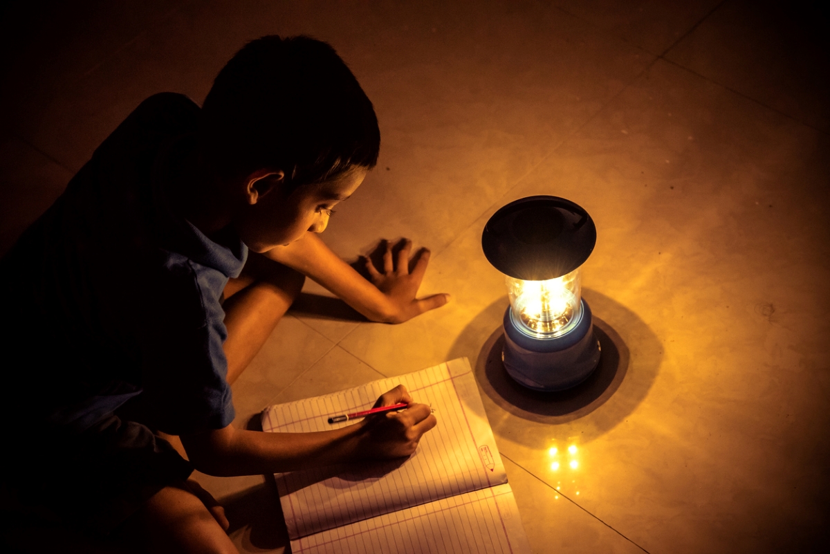 Boy using solar powered lamp