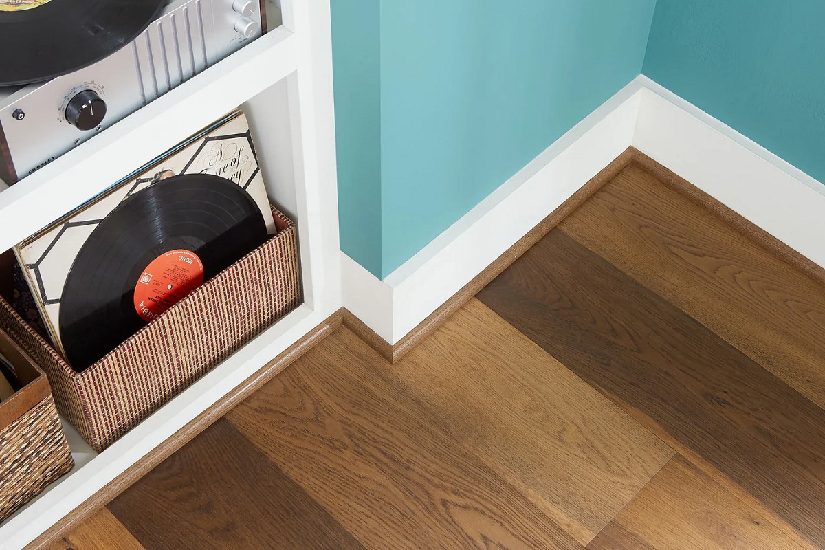 Quarter round molding along the wall with wooden floors.