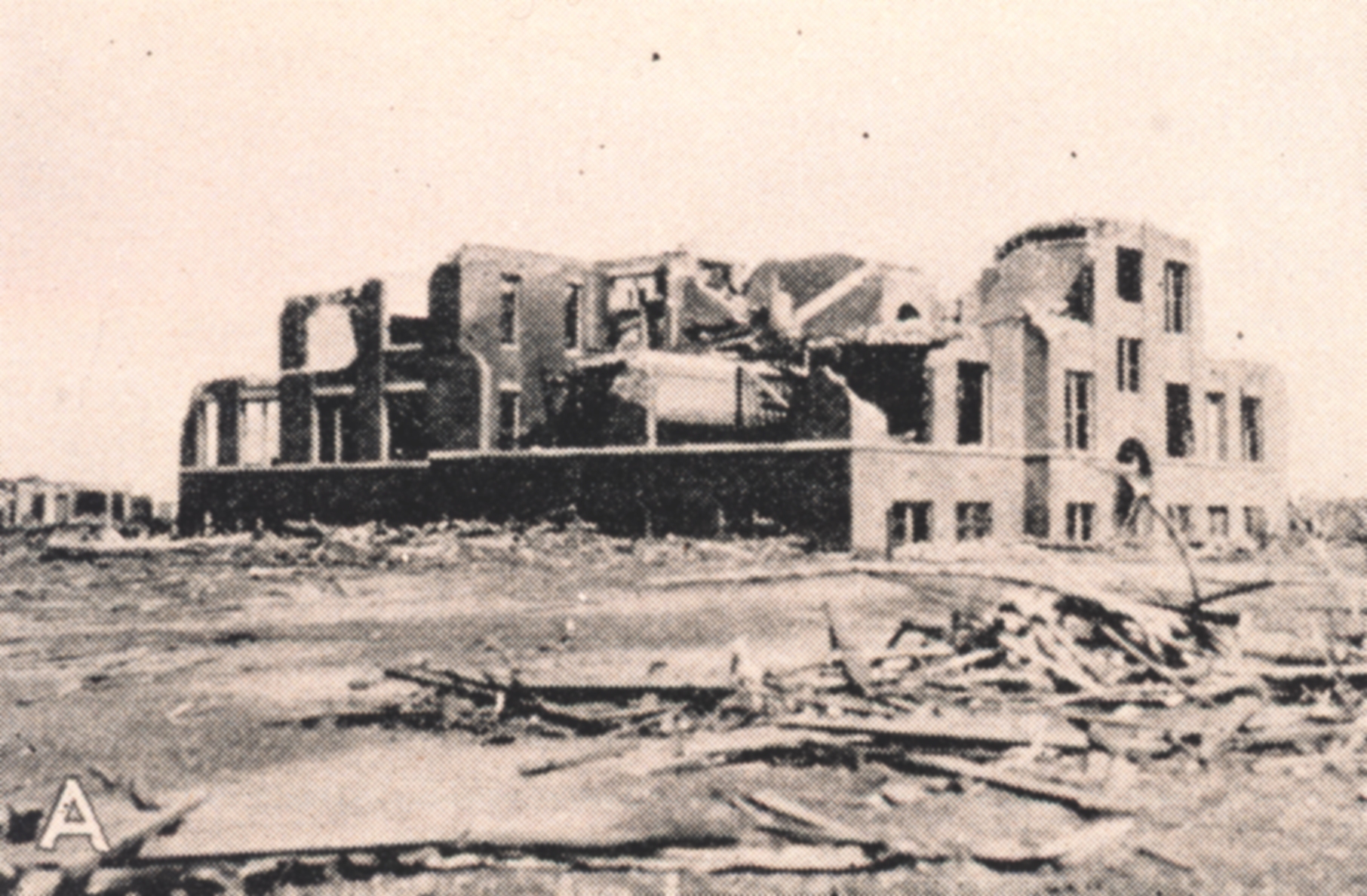 old archival photograph of ruined building in the wake of the tri-state tornado