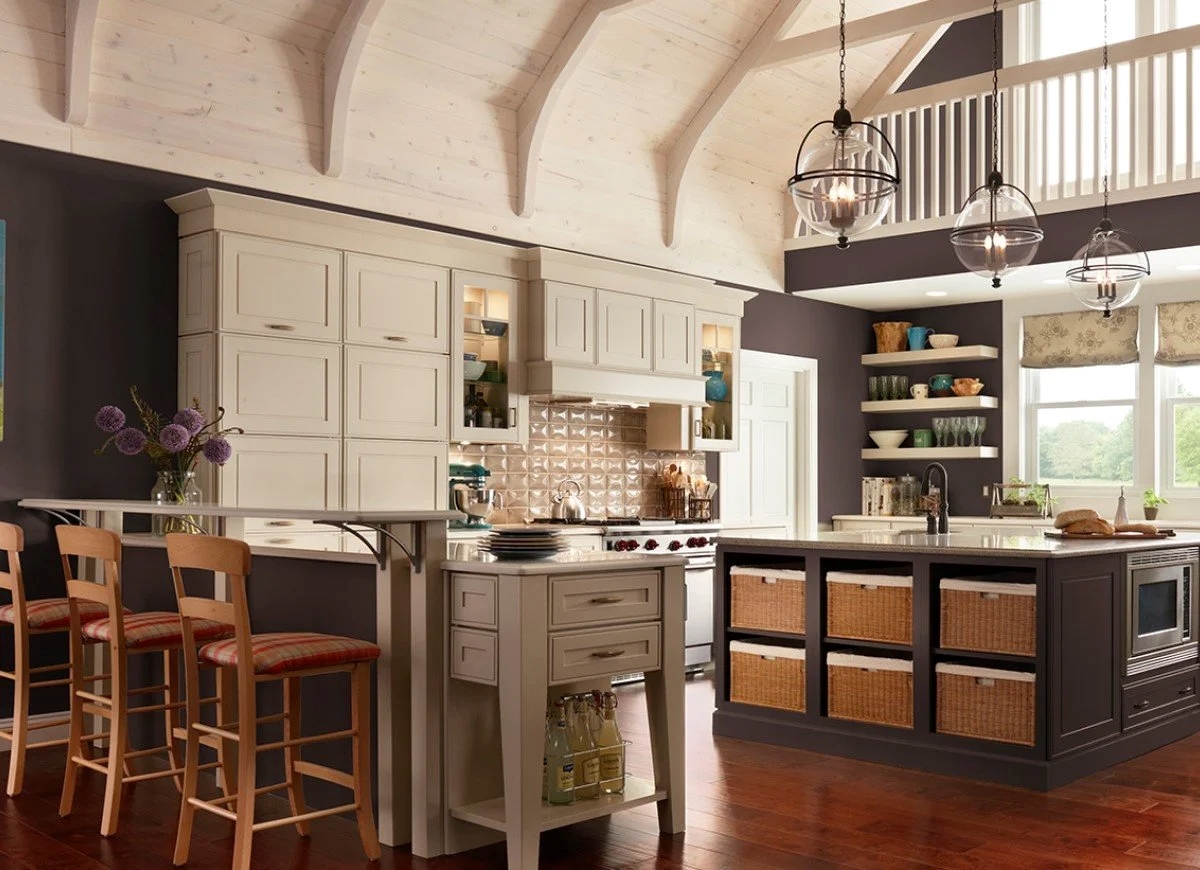Very large kitchen painted in brown with white cabinets.