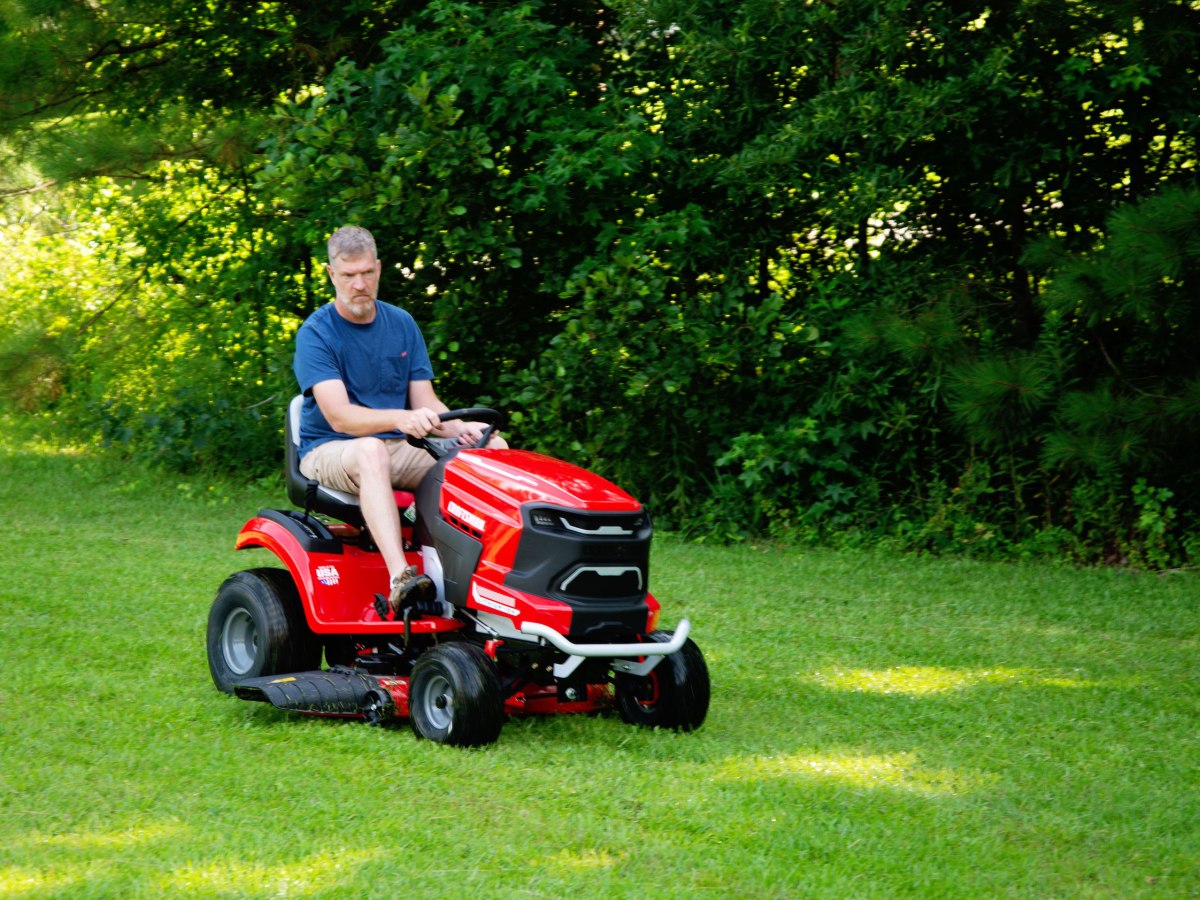 A person riding a craftsman battery ride-on mower