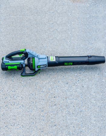 The Ego Power+ 650 CFM 56V Leaf Blower sitting on cement.