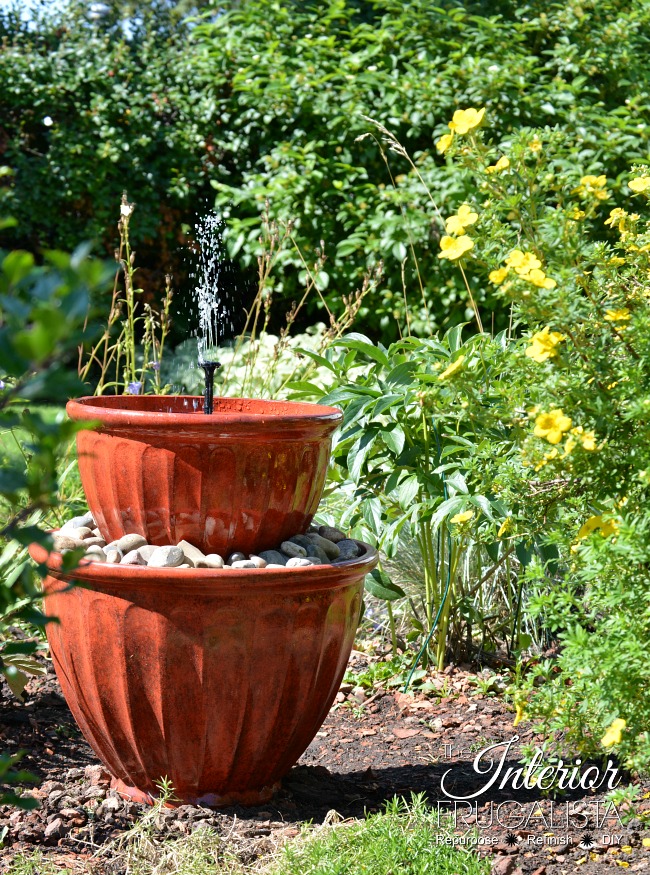 fountain made from plant pots in a garden