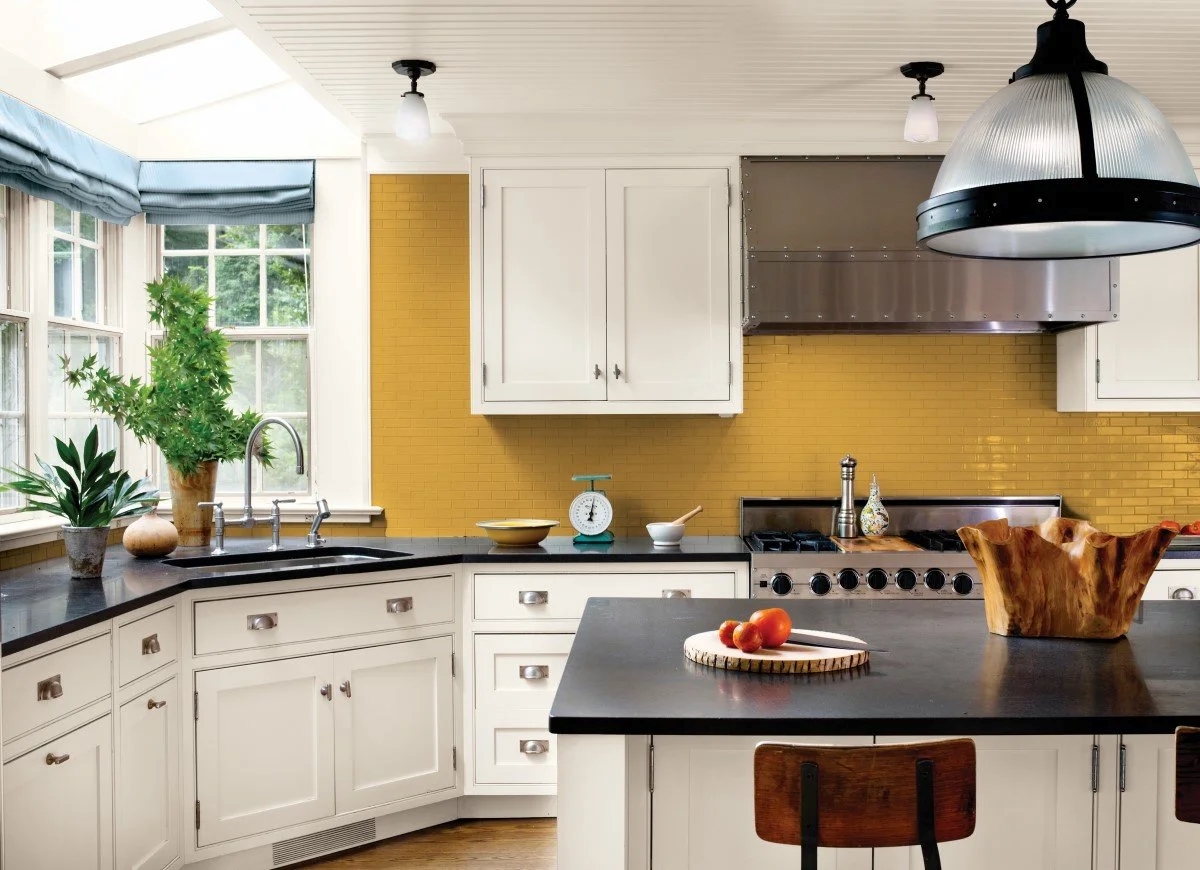 Large kitchen with yellow tile backsplash.