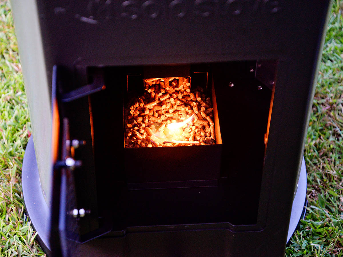 Wood pellets on fire inside a Solo Stove Tower Patio Heater firebox.