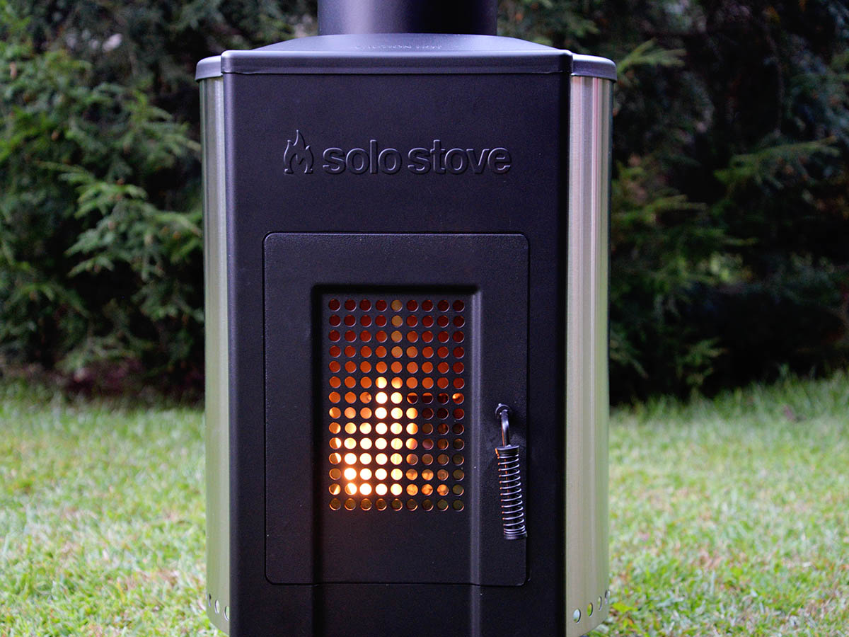 Glowing fire inside the fire box of a Solo Stove Tower Patio Heater.