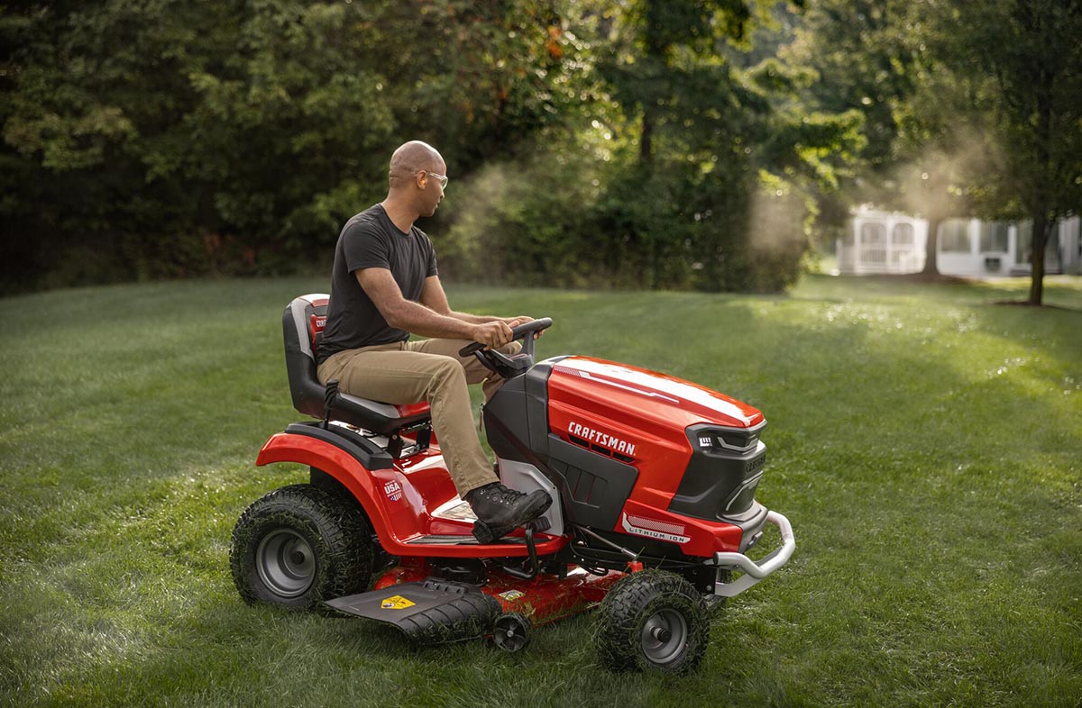 A person using the best battery-powered lawn mower option to mow a large lawn.