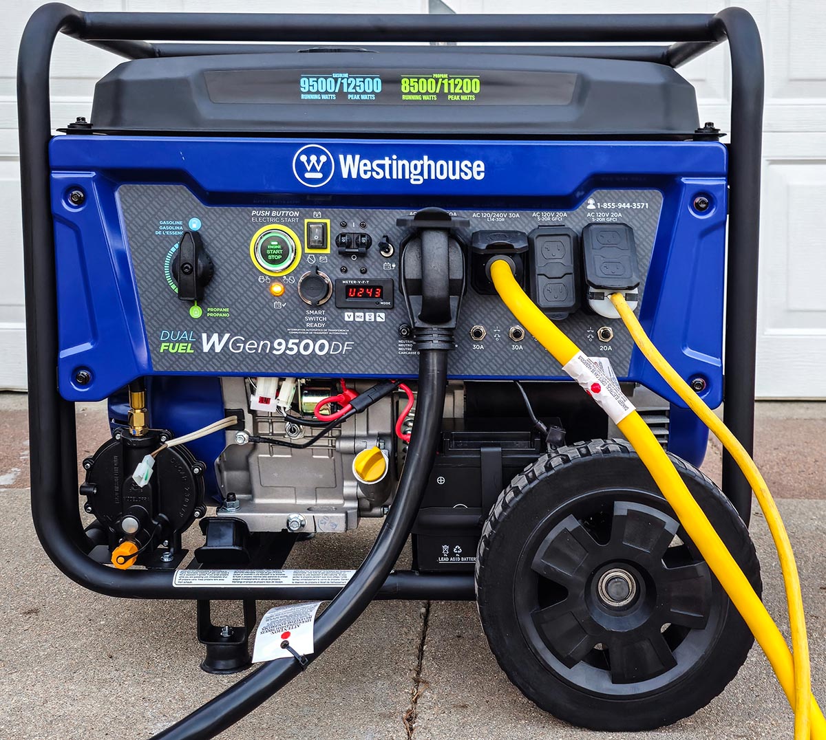 Westinghouse WGen9500DF Generator on concrete driveway with large cords plugged in.
