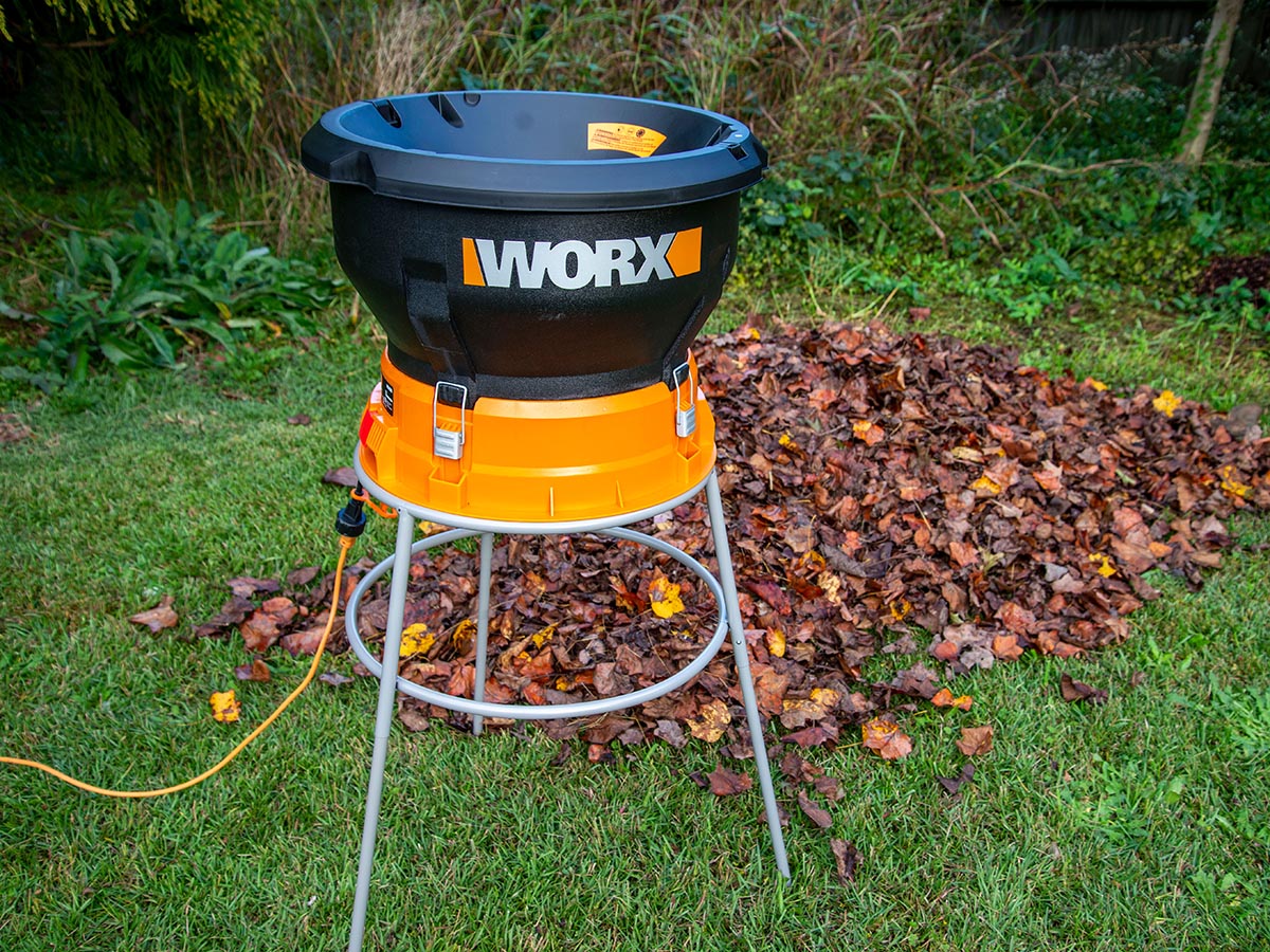 Worx leaf mulcher set up next to a pile of leaves