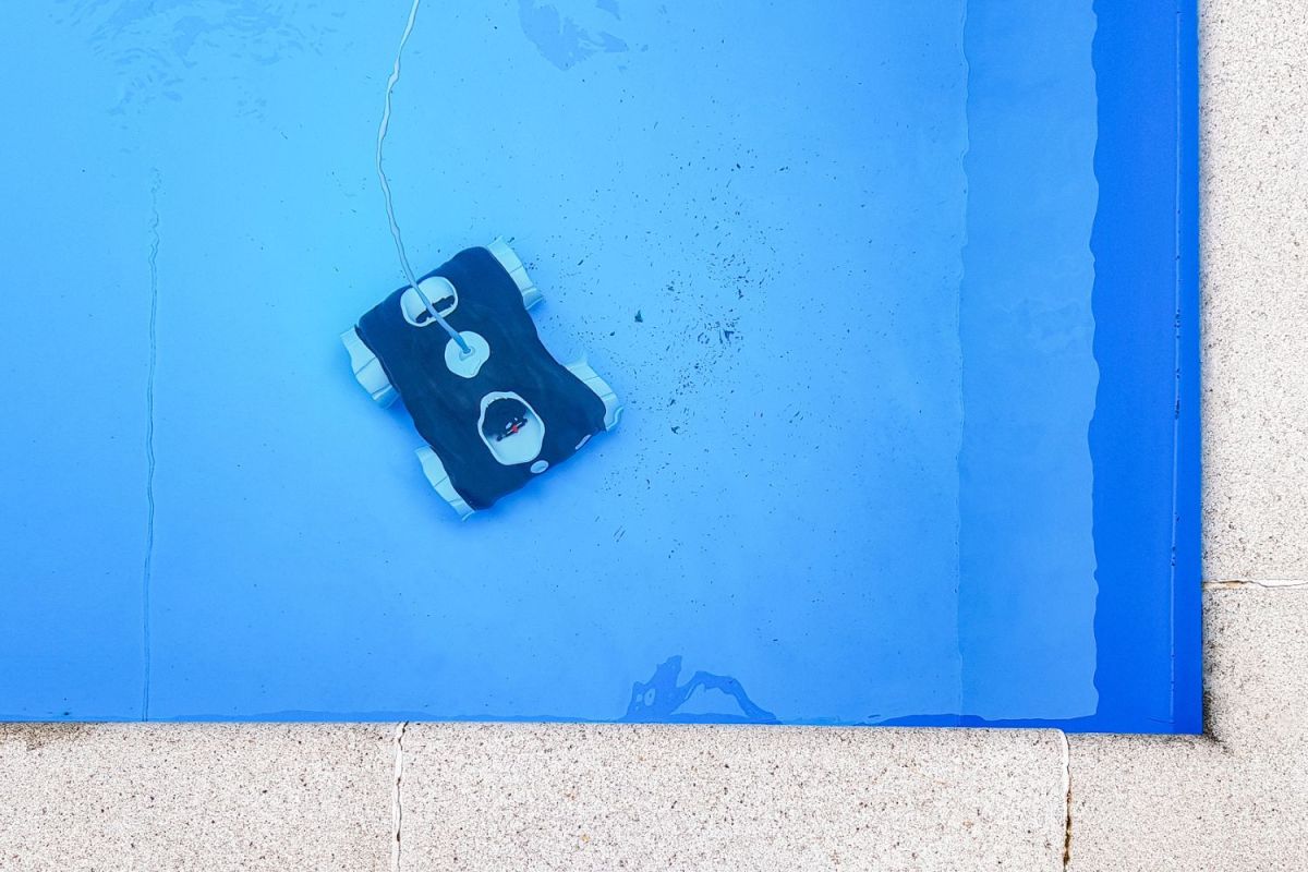 The best cheap robotic pool cleaner option cleaning debris off the bottom of a swimming pool.