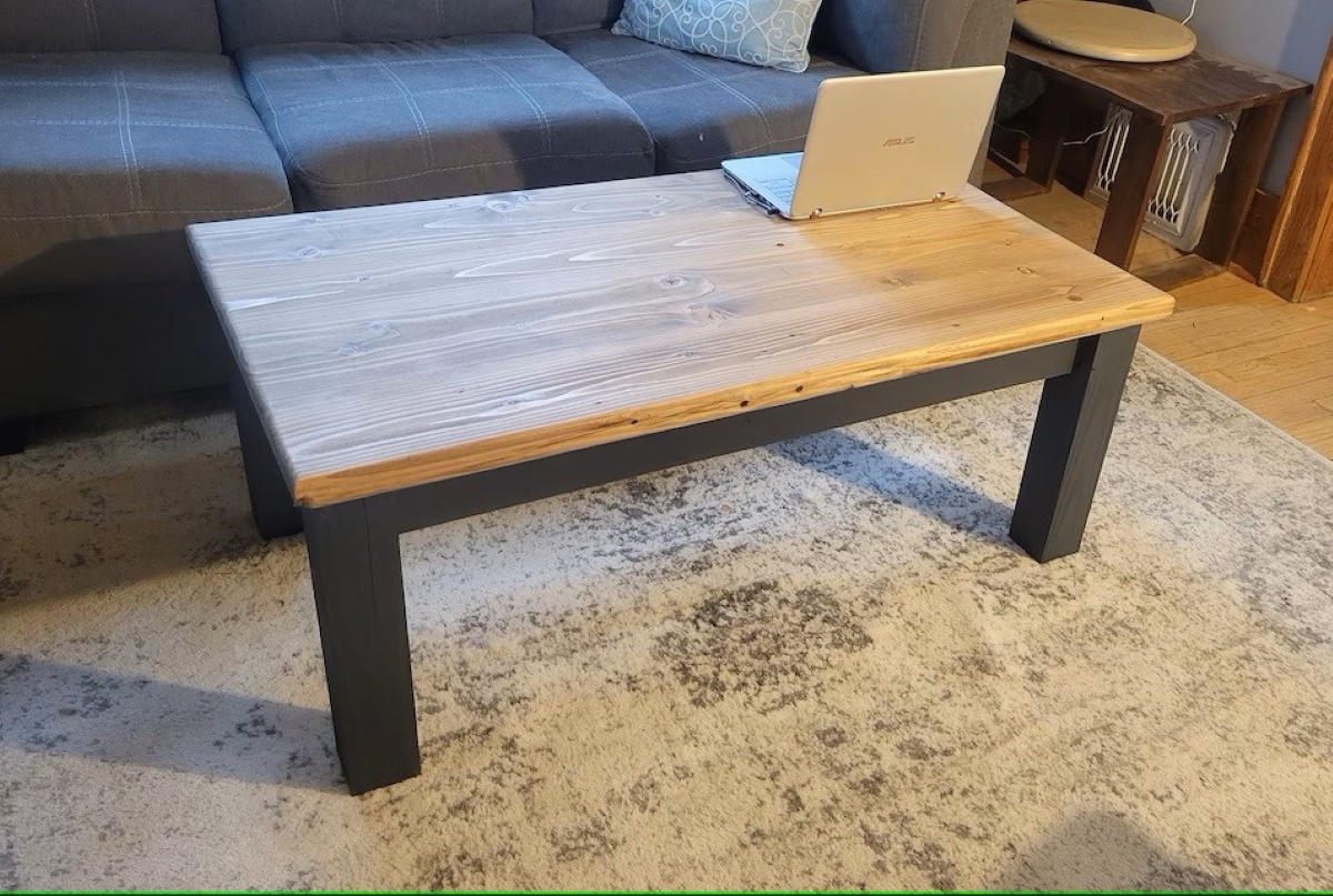 Wooden coffee table with laptop.