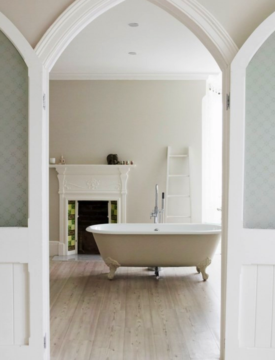 view through doorway into bath room with claw foot tub and grey walls