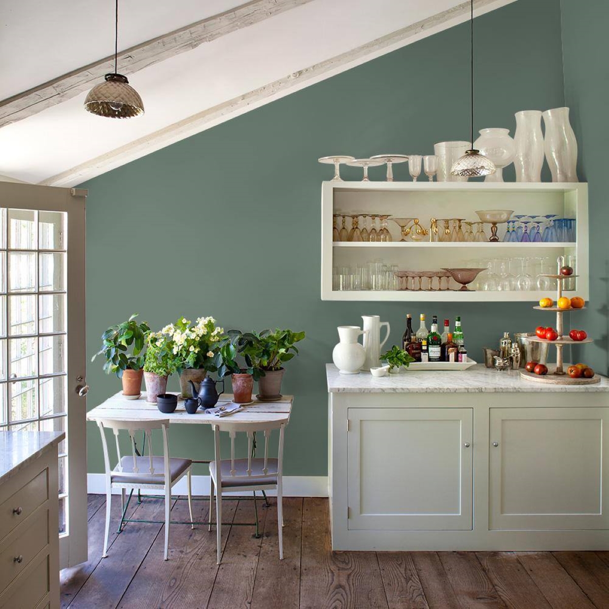 Small kitchen with green wall.