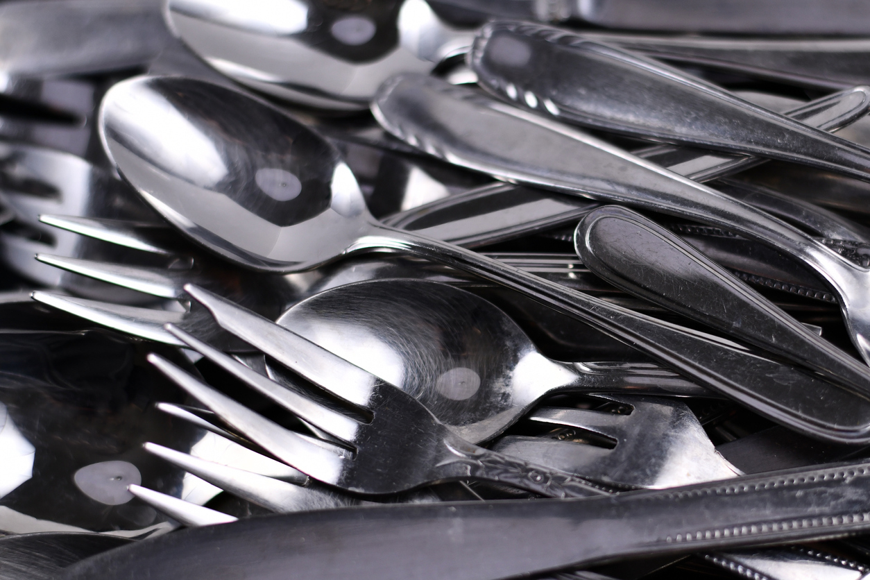 A close view of a pile of silverware.