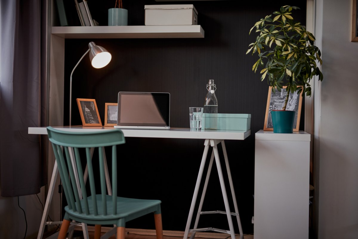 interior of modern home office with grey walls and small desk