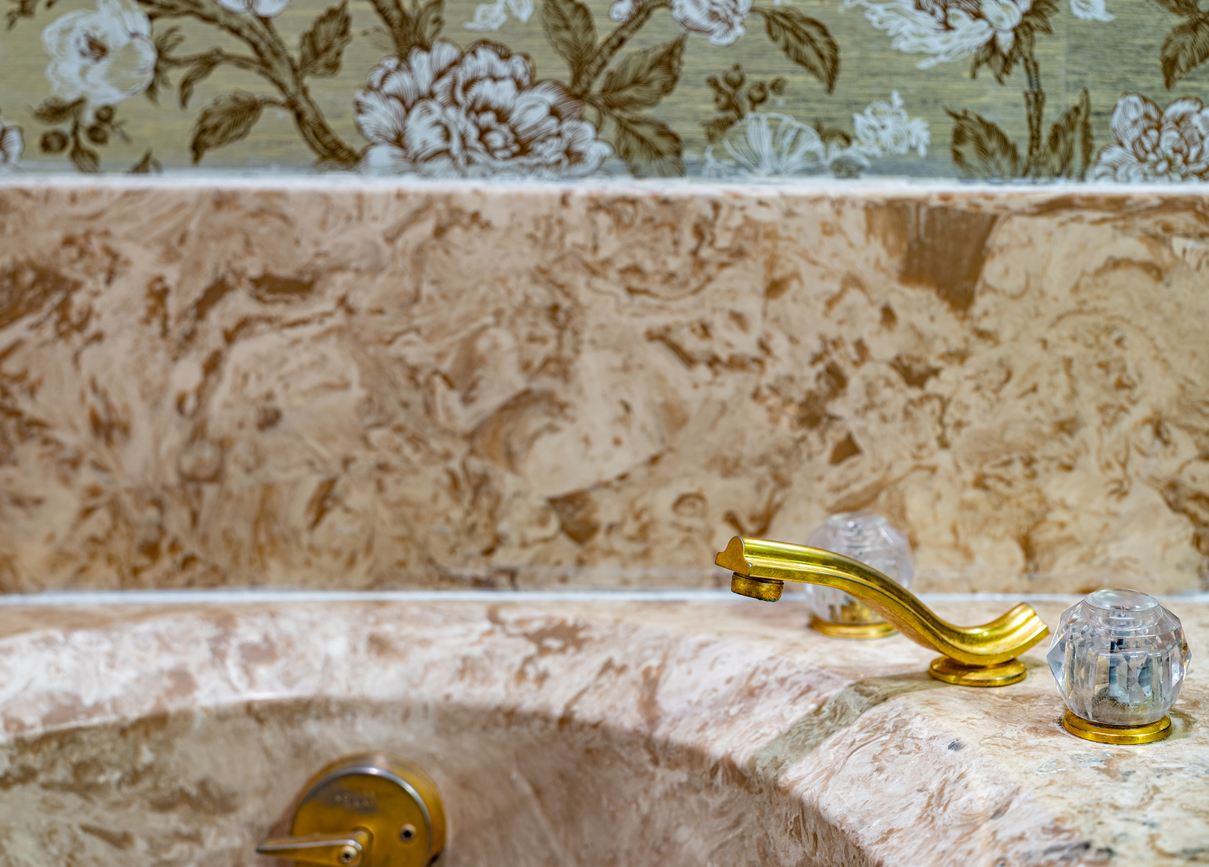 retro-bathtub-with-marbled-stone-and-brass-faucet