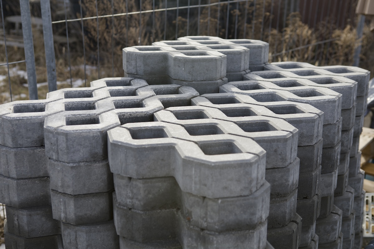 A stack of permeable concrete grass driveway pavers waiting to be installed
