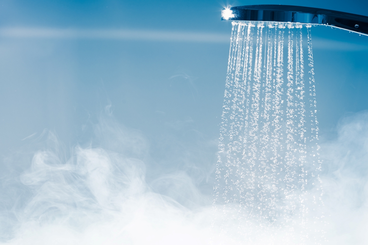 Water coming from shower head with steam.