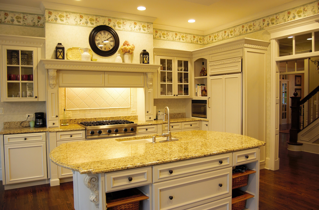 cream-colored-kitchen-with-quartz-countertops-and-floral-wallpaper-border-near-the-ceiling