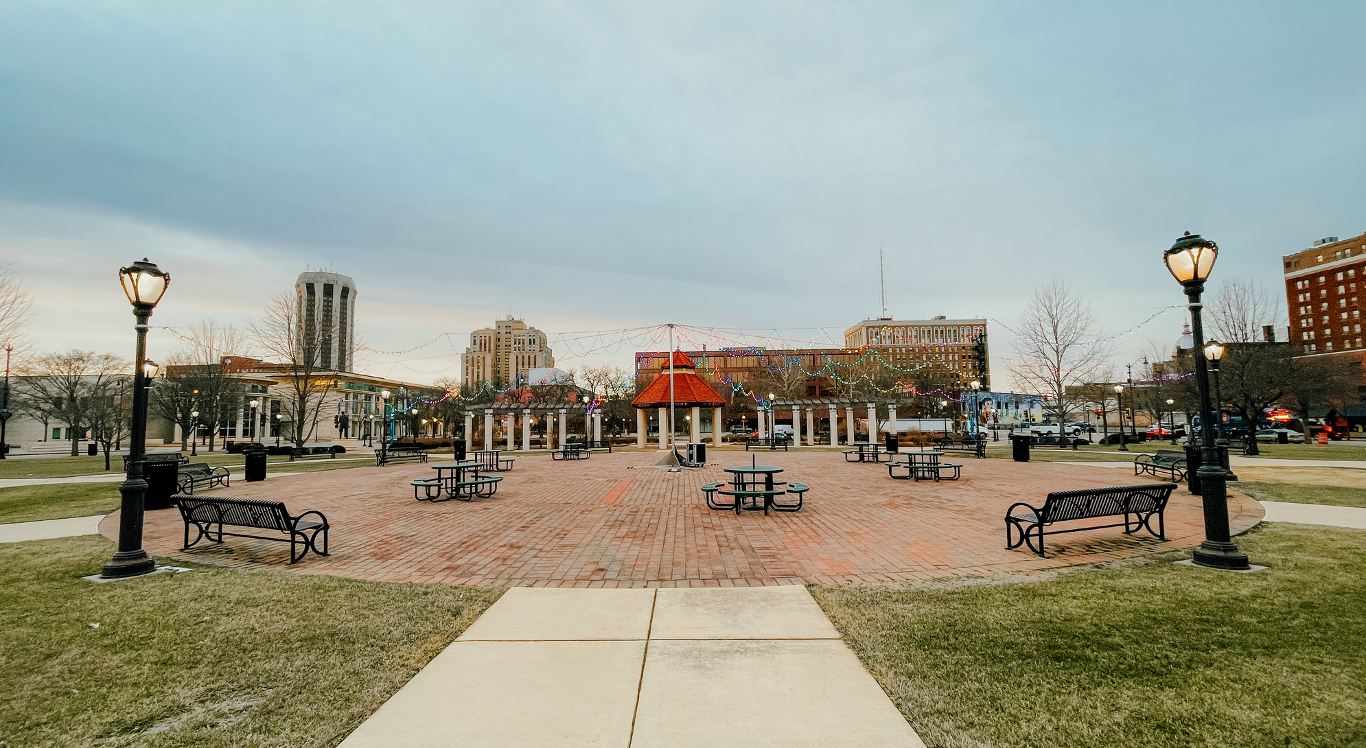 Looking out over the historic district Union Square Park in Springfield, Illinois. Charming park benches and vintage lamps in winter just after sunrise.