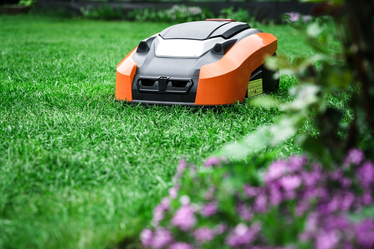 Robotic lawnmower in garden.