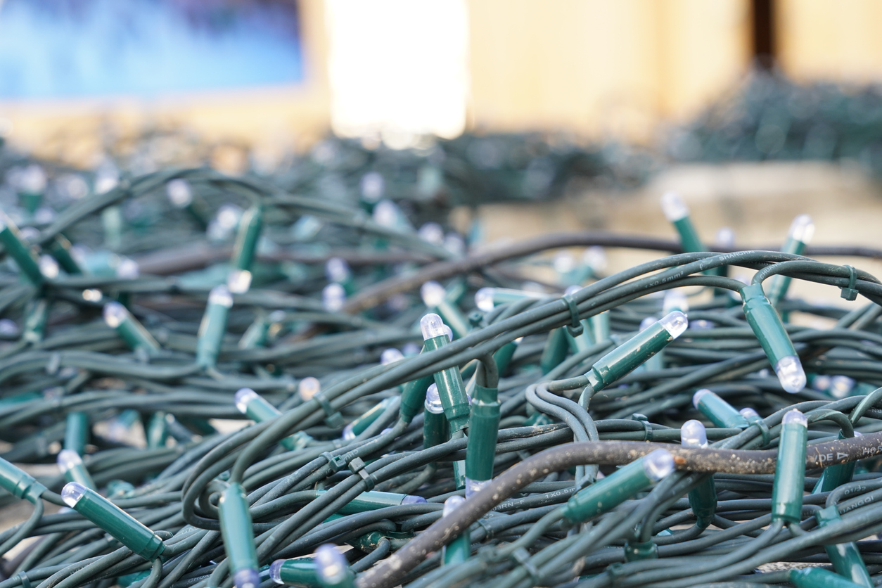 A close up of a cluster of christmas lights gathered together in storage
