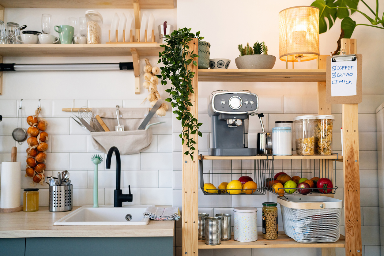 Modern domestic kitchen, with a wooden shelf for a coffee maker, fruit and other utensil