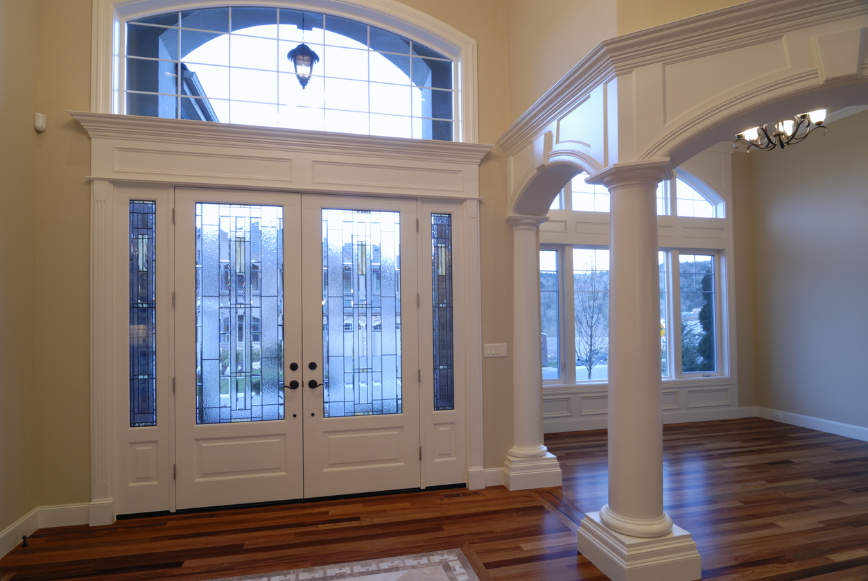 interior entryway in large house with transom windows above door and windows