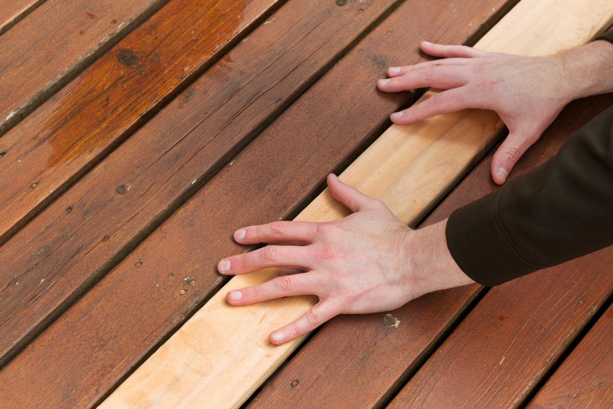 Person placing hands on new deck board