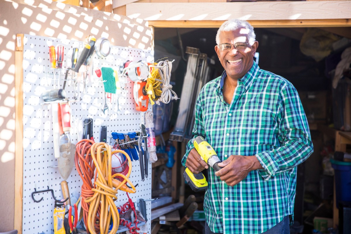 A senior black man in his tool shed