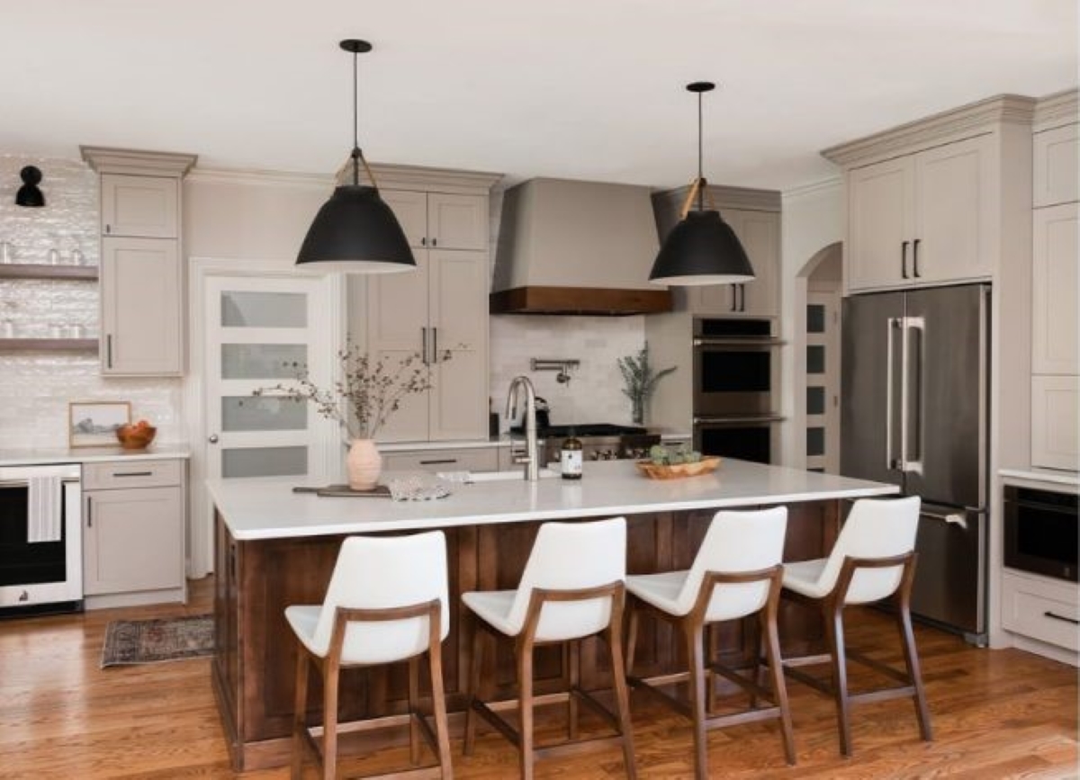 Kitchen island with white chairs.