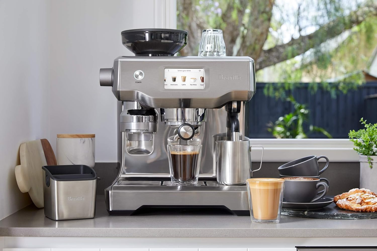 Breville Barista Touch Espresso Machine on a Kitchen Counter with Espresso Drinks