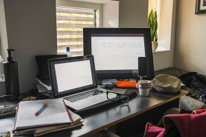 A home office setup with two computers on a desk.