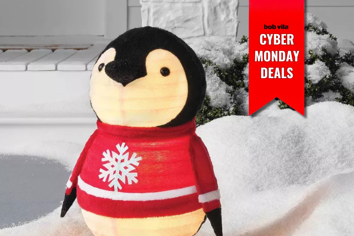Holiday Decorations for Under $100 on Cyber Monday, Including a Penguin in a Sweater Standing on a Snowy Lawn