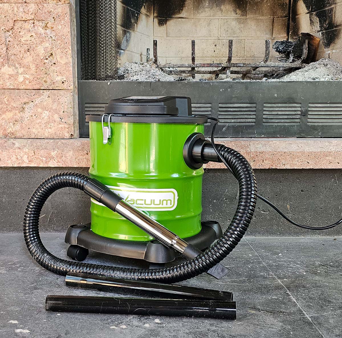 The PowerSmith Ash Vacuum in front of a dirty fireplace full of ashes.