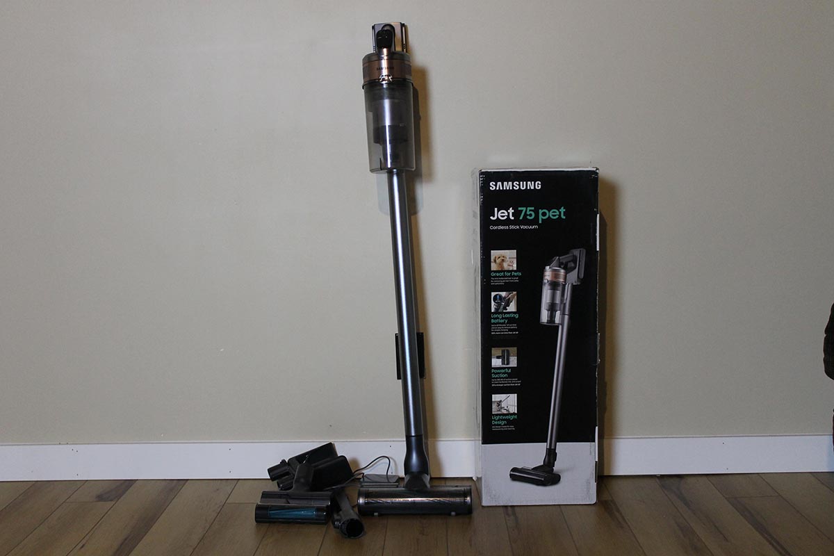 Samsung Jet 75 Pet cordless stick vacuum on hardwood floor next to its box