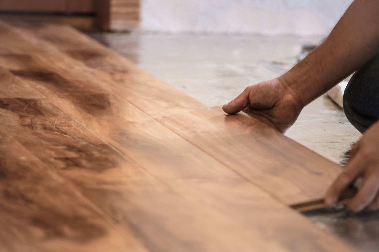 Hands of a Man Shown Installing Solid Wood Floor