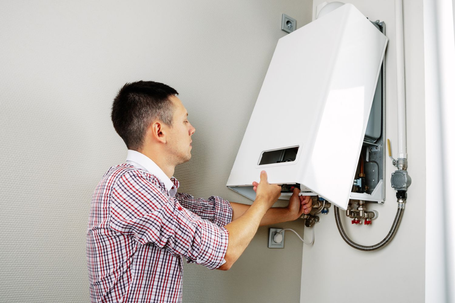 How Much Does a Boiler Service Cost: Expert in boiler repair demonstrating service costs
