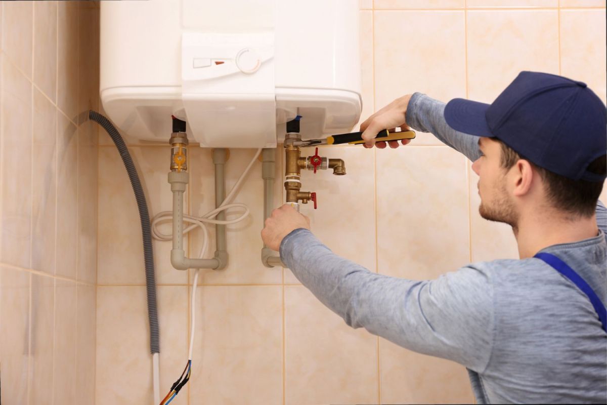How Much Does a Boiler Service Cost: Technician repairing a boiler, illustrating the cost of boiler service