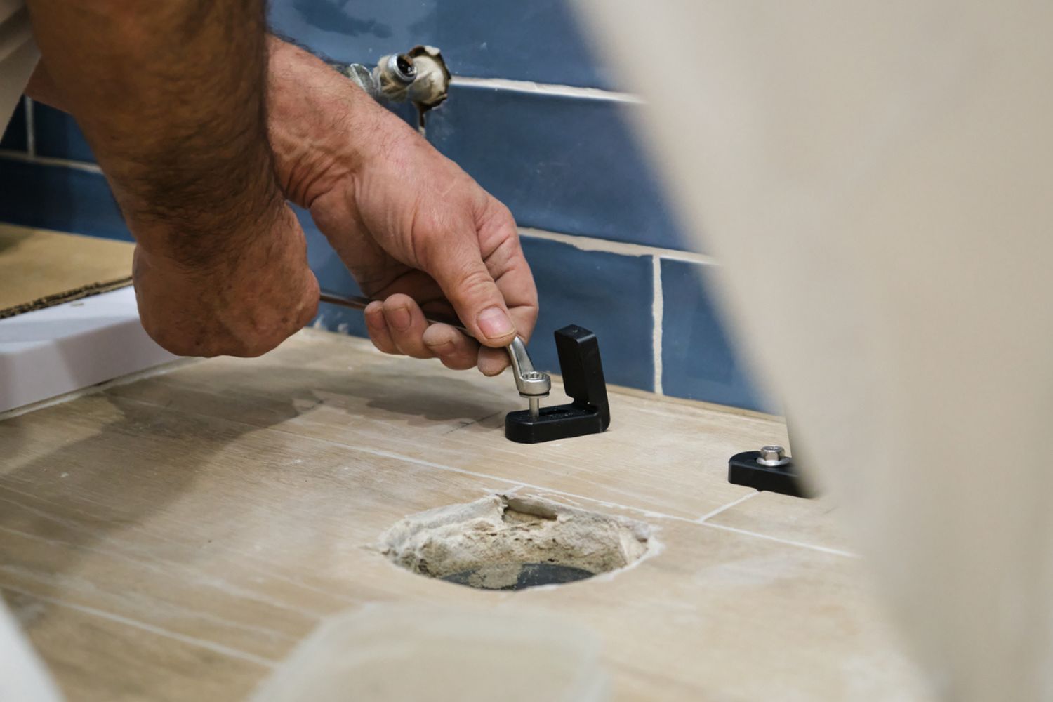 How Much Does It Cost to Replace a Toilet Flange: Bathroom maintenance: plumber replacing the toilet flange