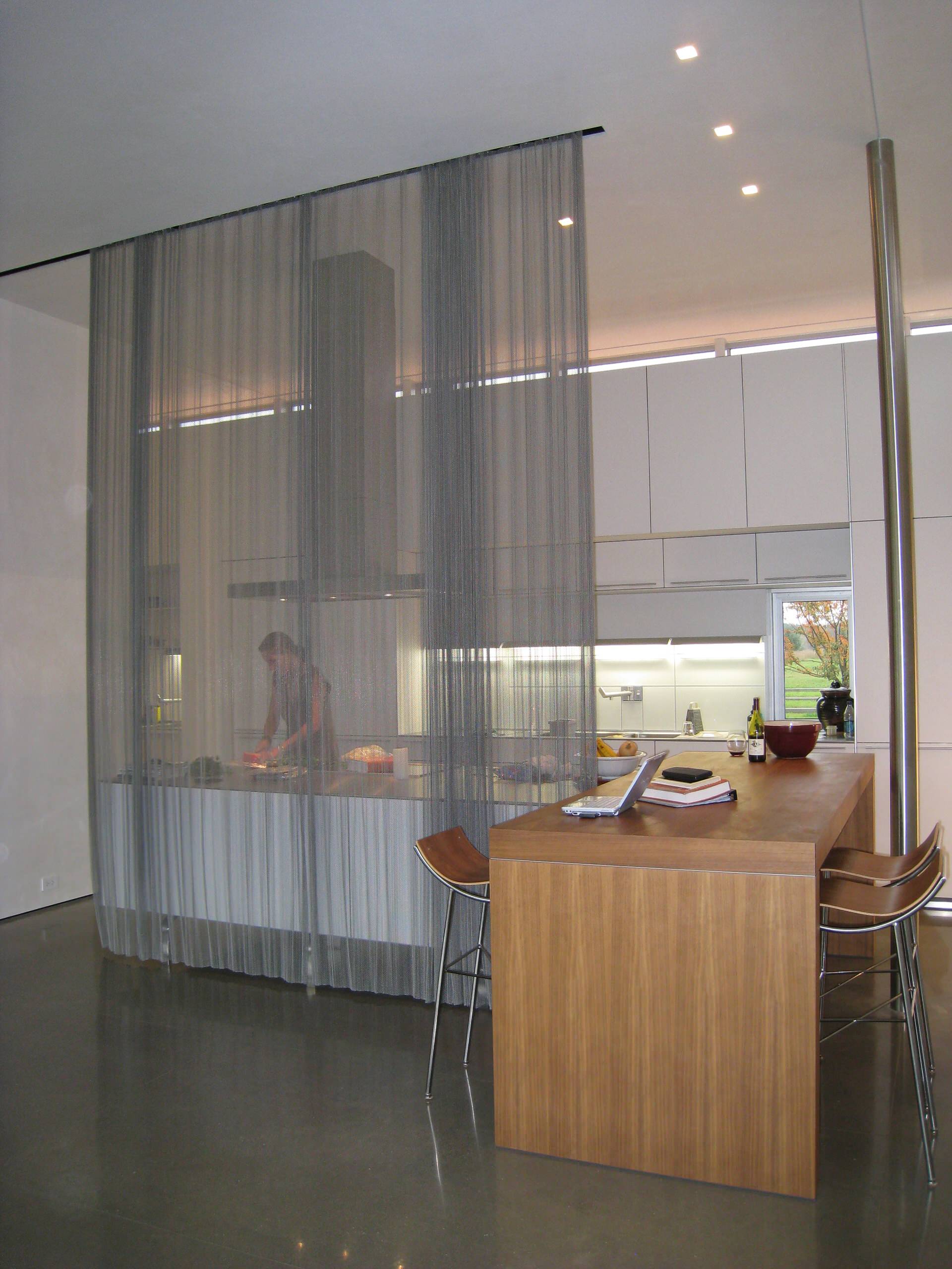 A large curtain divider in a small kitchen.