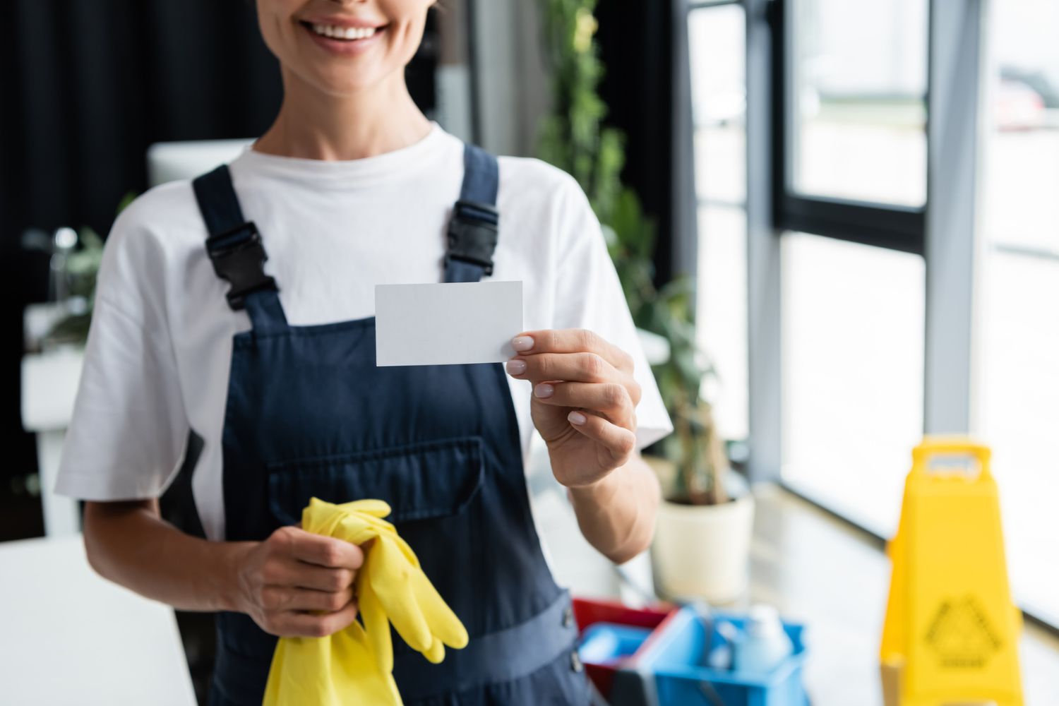 How to Get Clients for a Cleaning Business: Professional window cleaner showcasing their cleaning services on a business card