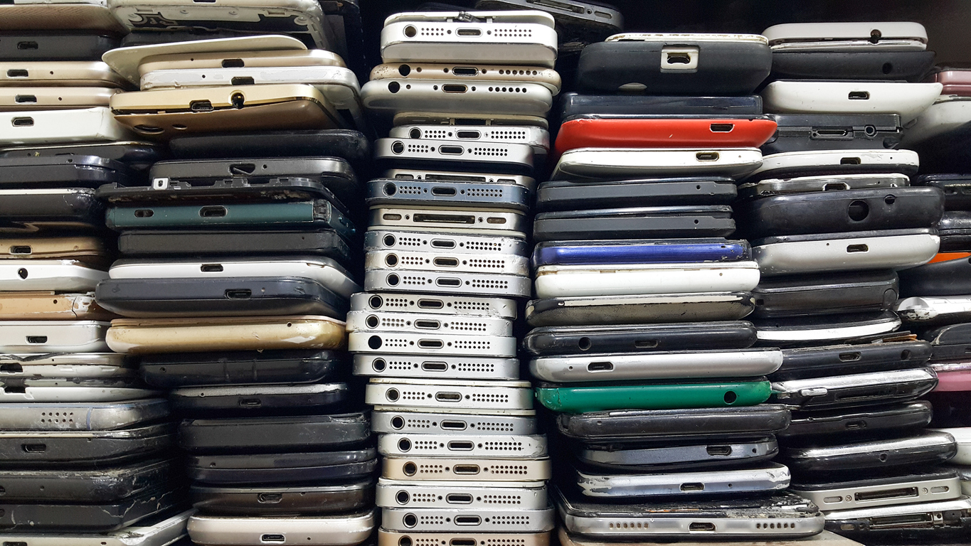 A close view of rows of stacked cell phones traded in.