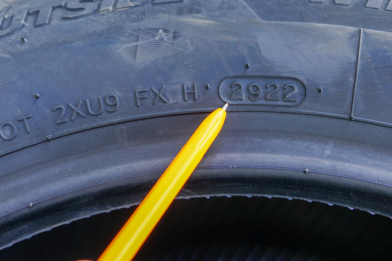 Side view of new tire with designation of week and year of tire production, tire marking