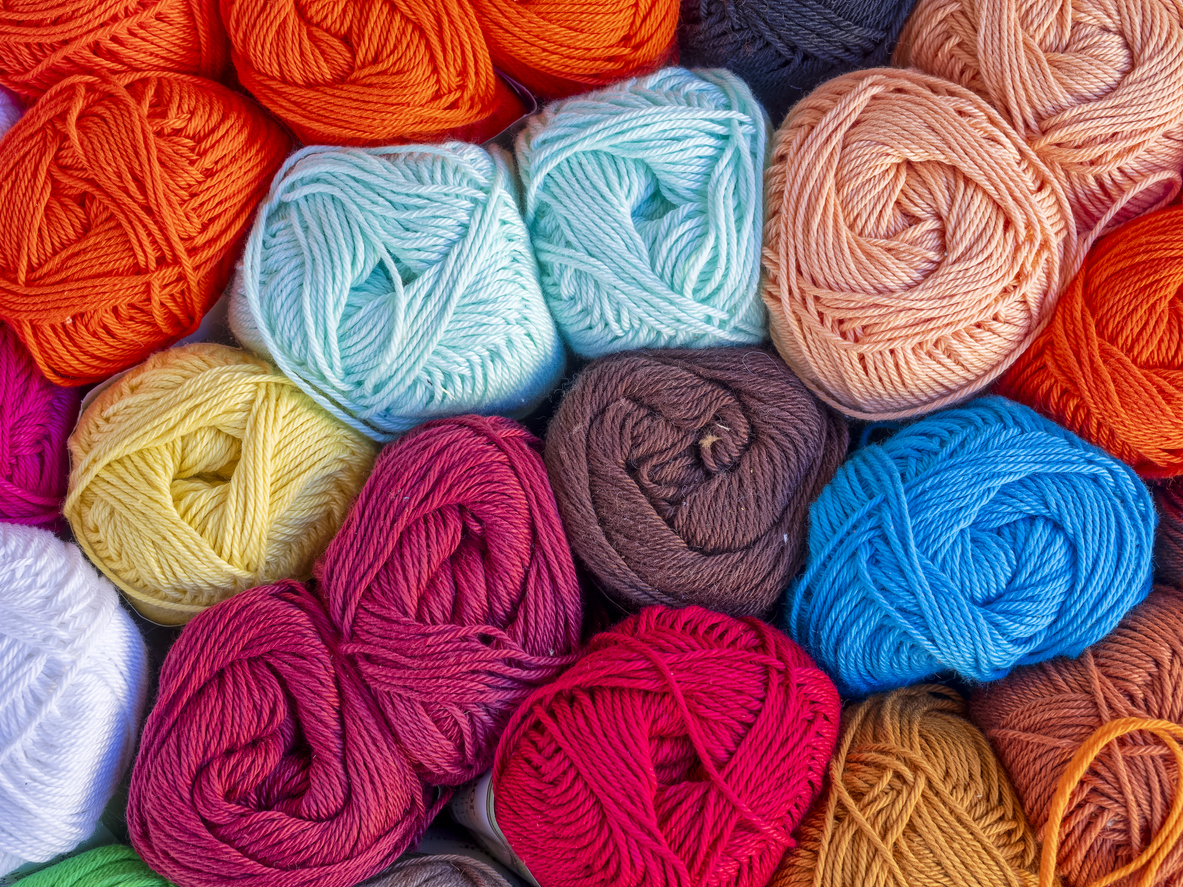 A close view of several colorful bunches of yarn.