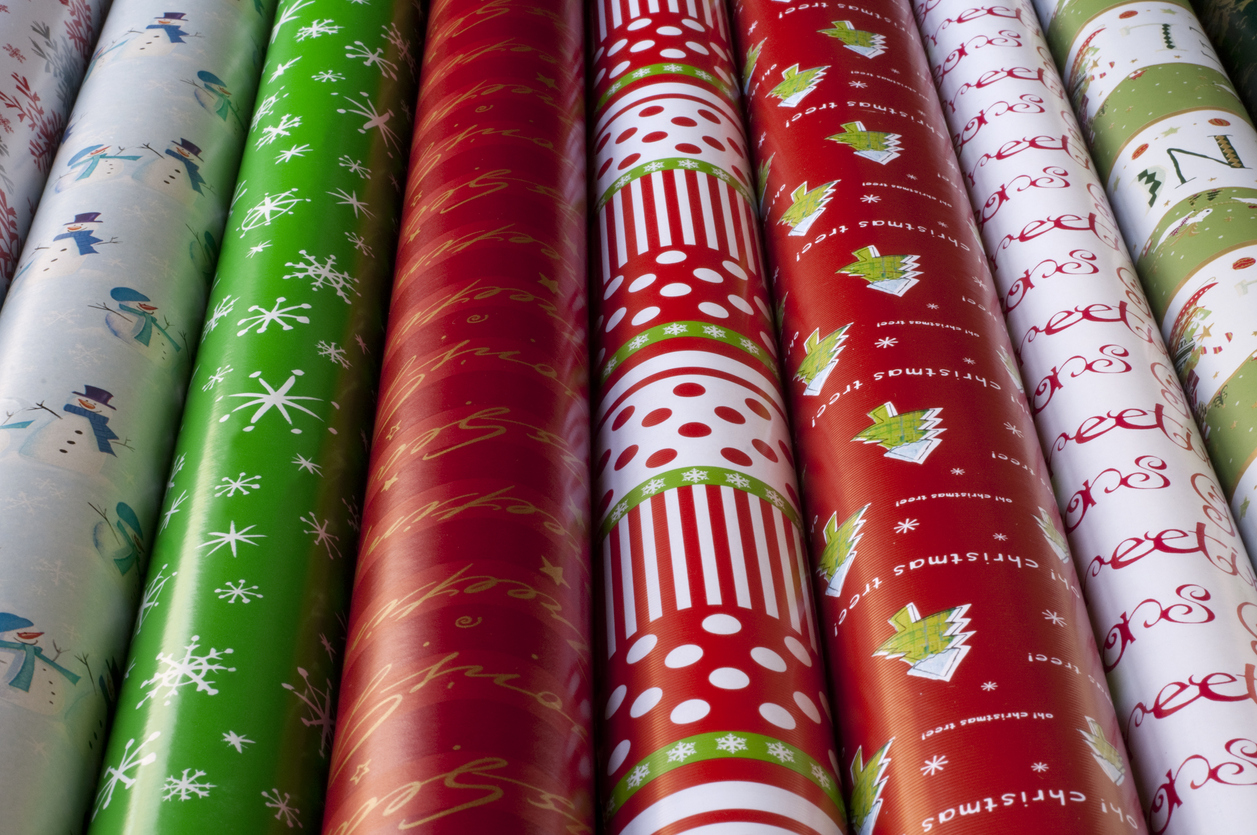 Close view of several rolls of Christmas wrapping paper.