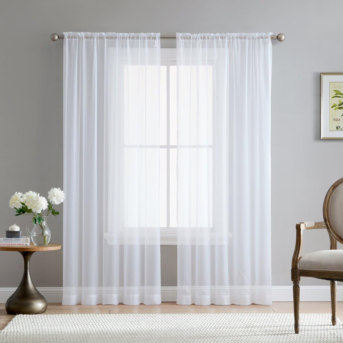 A window covered by sheer curtains in a kitchen.