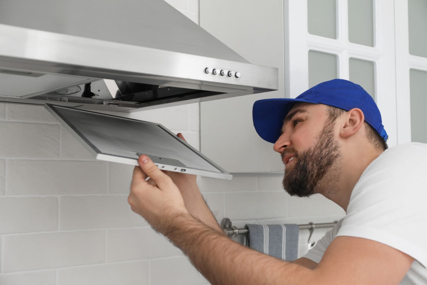 How Much Does Range Hood Installation Cost: range_hood_installation_cost_Professional electrician installing a new range hood in a modern kitchen