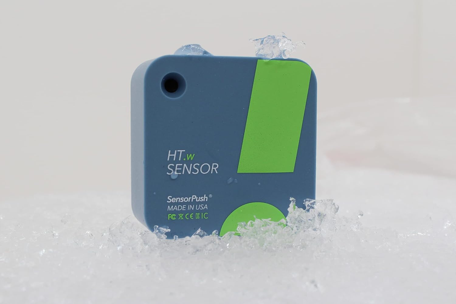 A hygrometer for measuring pool temperature is sitting in snow.