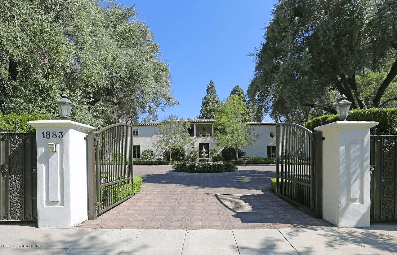 A Spanish style home sits behind a gated entrance.